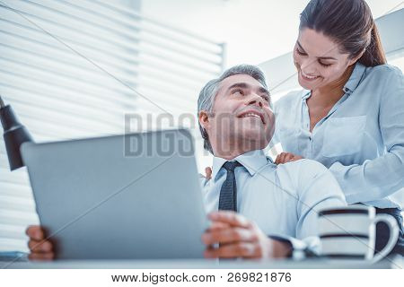 Joyful Partners Having A Romantic Relationship At Work