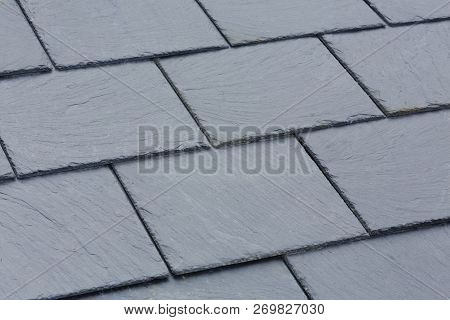 Closeup Of Traditional Grey Slate Roof Tiles On A Pitched Roof