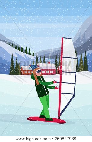 Woman Windboarding Windsurfing On Snow Over Small Village Houses Winter Snowy Mountains Hills Fir Tr