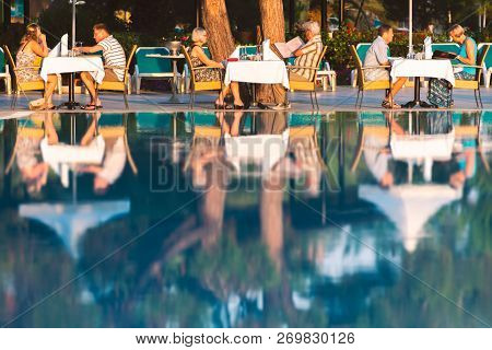 Istanbul, Turkey - July 9, 2014: People Dining At Hotel Near Pool. Chairs And Table Near Pool At Hot
