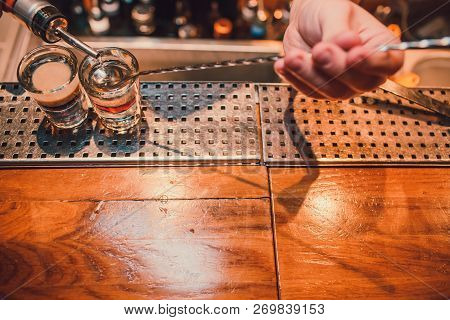 Bartender Making Shots On Black Bar With Reflection.