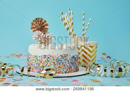 Delicious Cake, Plactic Cups And Drinking Straws On Blue Background With Confetti