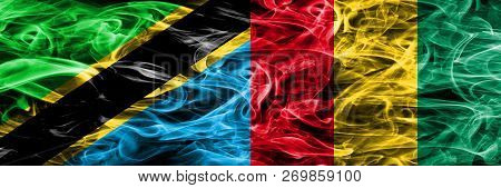 Tanzania Vs Guinea, Guinean Smoke Flags Placed Side By Side. Thick Colored Silky Smoke Flags Of Tanz