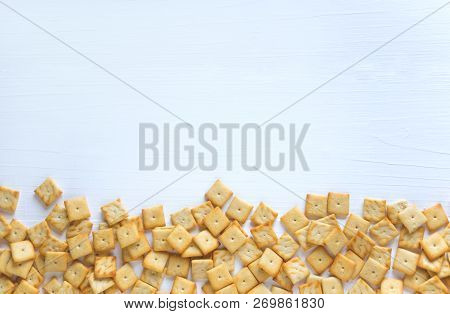 Background For A Banner With Crackers. Photo Of Crackers On A White Wooden Background. Cracker Backg