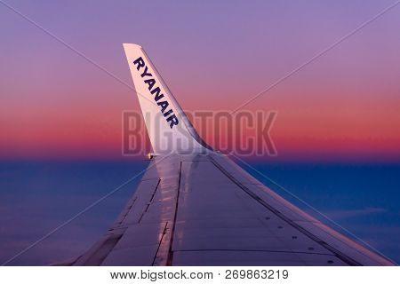 Gdansk, Poland - September 7, 2018: Ryanair Logo In The Wing Of The Airplane With Blue Red Sky As Th