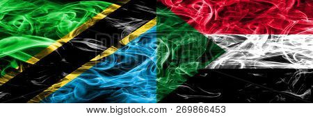 Tanzania Vs Sudan, Sudanese Smoke Flags Placed Side By Side. Thick Colored Silky Smoke Flags Of Tanz