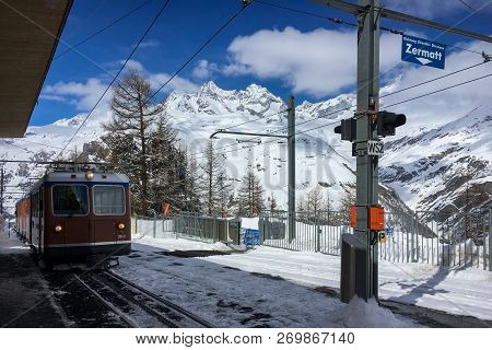 Zermatt, Switzerland - March 20, 2018: A Train Of Traditional Track Railway Gornergratbahn Is Approa