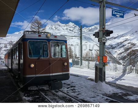 Zermatt, Switzerland - March 20, 2018: A Train Of Traditional Track Railway Gornergratbahn Is Approa