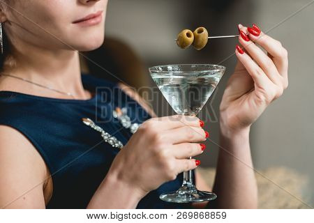 Dry Martini Cocktail In Womans Hands With Red Manicure. Luxery Hotel Lobby Bar.