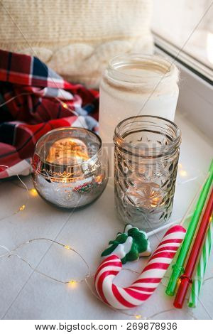 Still Life Details With Candles, Toy Candy Cane And Garland. Scandinavian Hygge Concept, Christmas A