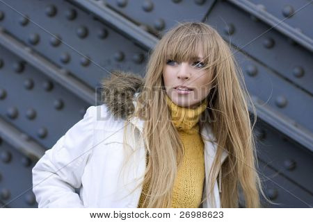 The image of a girl who walks on the background of the city