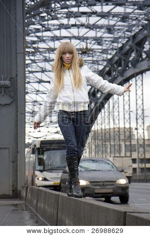 The image of a girl who walks on the background of the city