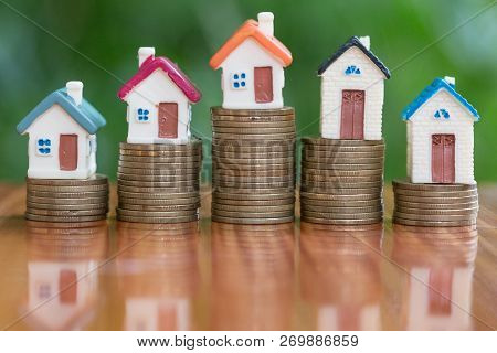 Mini House On Stack Of Coins,money And House,  Mortgage, Savings Money For Buy House And Loan To Bus