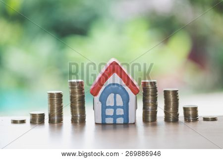 Mini House On Stack Of Coins,money And House,  Mortgage, Savings Money For Buy House And Loan To Bus
