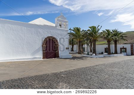 White Church And Palm Trees In Femes In Lanzarote. Canary Islands. Spain