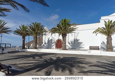 White Church And Palm Trees In Femes In Lanzarote. Canary Islands. Spain
