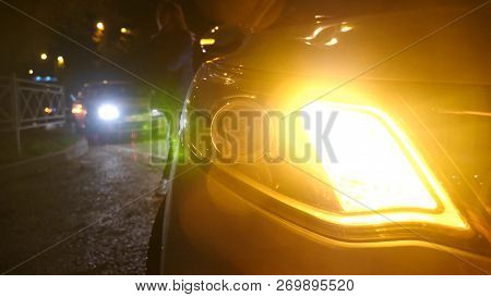 Night. Car Blinker Light. Emergency Car Warning Light On The Background Of Moving Cars On A Night Ro