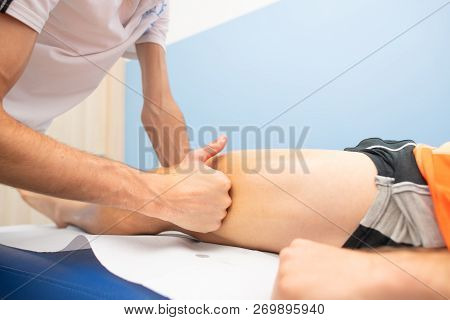 Massage Lata Band To An Athlete By A Physiotherapist