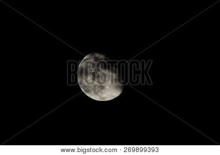 Almost Full Moon Over A Dark Black Sky