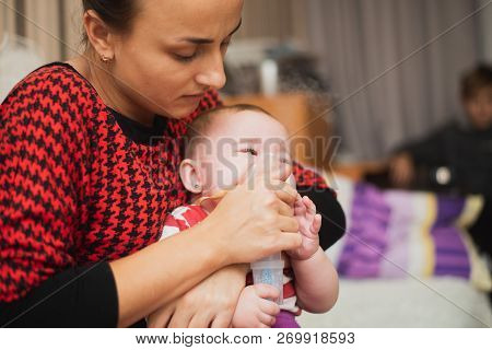 Mom Makes Inhalation Of The Child, Holding Hands