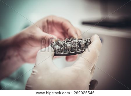 Man Holds In Hands Object Printed On Metal 3d Printer In Laborat