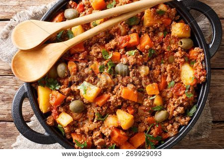 Picadillo Recipe ground Beef, Carrot And Potatoes Cooked In A Tomato Sauce Closeup On A Pan. Horizon