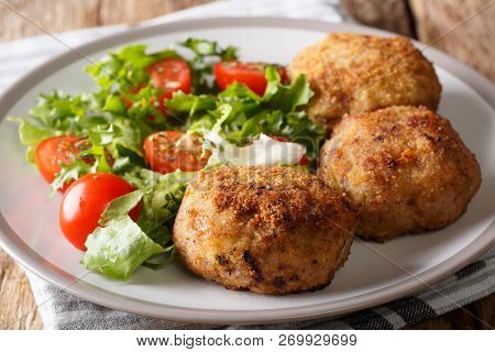 Danish Food: Traditional Breaded Pork Patties Karbonader Served With Fresh Salad Close-up On A Plate