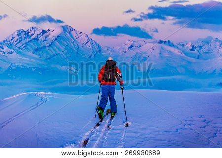 Skitouring with amazing view of swiss famous mountains in beautiful winter powder snow of Alps. 