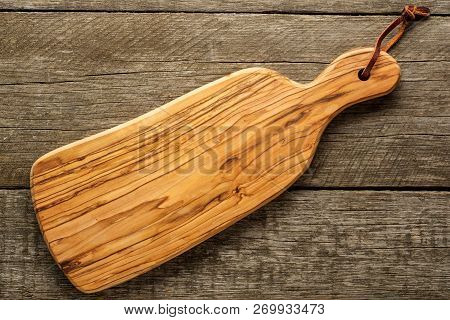 Composition With Olive Wood Board On Rustic Background With Cjpy Space