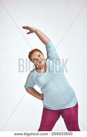 Amusing, Red Haired, Chubby Woman Is Doing Exersizes