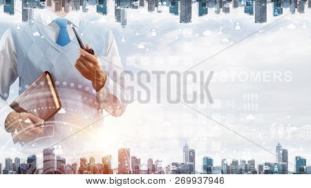 Double Exposure Of Confident And Young Businessman In Smart-casual Wear Smoking Pipe And Modern City