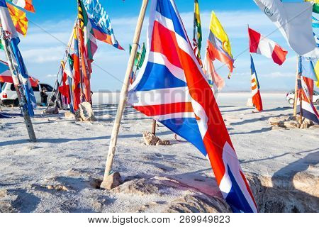 Salar de Uyuni, Bolivia - 21 October 2018: Sunshine bright flags from different countries