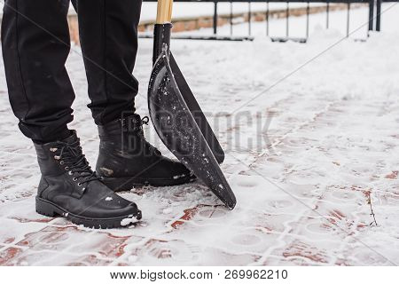 After A Snowfall, A Man Clears Snow From The Road In Winter, Work In The Winter Season.