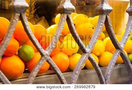 Groups Of Three Kind Of Citrus Fruits And Metal Decorations Of A Showcase