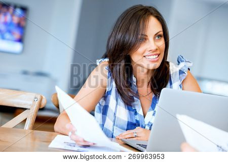 Woman with papers in their living room