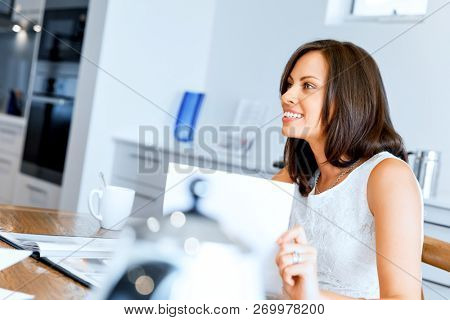 Woman with papers in their living room