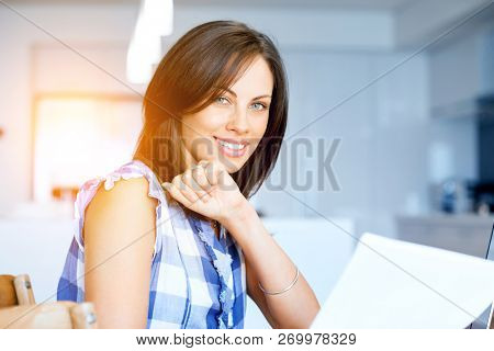 Woman with papers in their living room