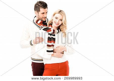 Romantic Couple In Knitted Scrafs Hugging Isolated On White