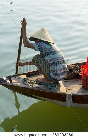 Hoi An Vietnam - February 20 2017 - The boatwoman  on the old national vietnamese boat down the Thu Bong river.