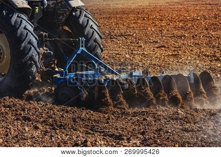 Agriculture,tractor Preparing Land With Seedbed Cultivator As Part Of Pre Seeding Activities In Earl
