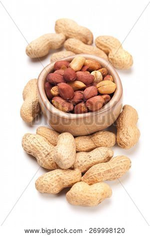 Roasted peanuts with peanut shells isolated on white background