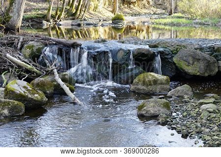 Beautiful View In Spring Of A Waterfall In A Small River