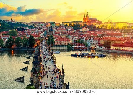 Aerial View Of Charles Bridge, Prague Castle And Vltava River In Prague, Czech Republic During Sunse