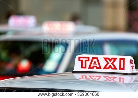 Taxi Car Is Waiting For A Passenger On The Street In Hong Kong, Special Administrative Region In Chi
