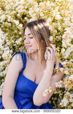 Sensual Calm Portrait Of Beautiful Hipster Woman In Blooming Bush With White Flowers Of Spirea. Copy