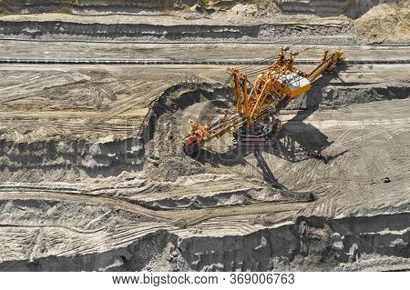 Aerial View Of Large Heavy Equipment Machine Mining Natural Resource. Coal Mining By Bucket Wheel Ex