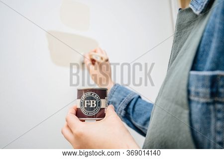 Paris, France - May 30, 2020: Woman Painting With Farrow And Ball Sample Pot New Colour On Her Wall 