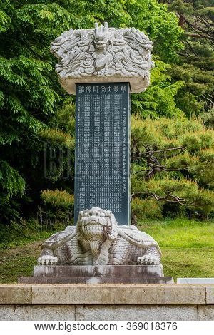 Haeinsa-gil, South Korea; May 26, 2020: Giant Turtle Stele With Dragon Capstone And Trees In Backgro
