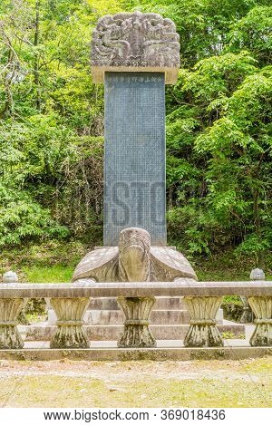 Haeinsa-gil, South Korea; May 26, 2020: Giant Turtle Stele With Dragon Capstone And Trees In Backgro