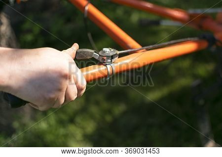 Man Farmer Plows The Land With A Cultivator. Agricultural Machinery: Cultivator For Tillage In The G